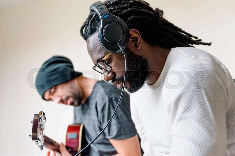 Artists producing music in their home sound studio, stock photo