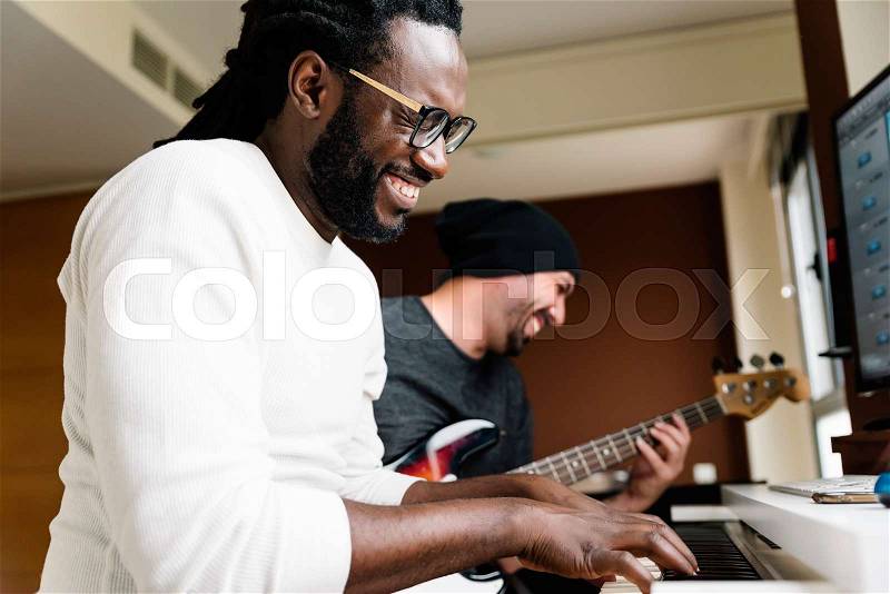 Artists producing music in their home sound studio, stock photo