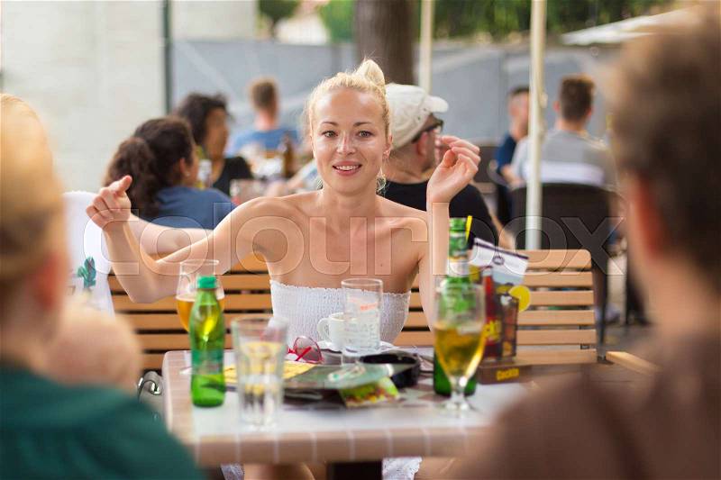 It is nice to see you. Group of friends enjoying a conversation on urban food market at random after work encounter. Pleasant free time socializing, stock photo