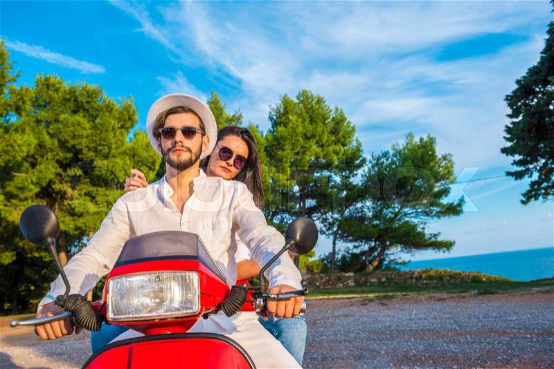 Happy free freedom couple driving scooter excited on summer holidays vacation. Young multiethnic couple, stock photo