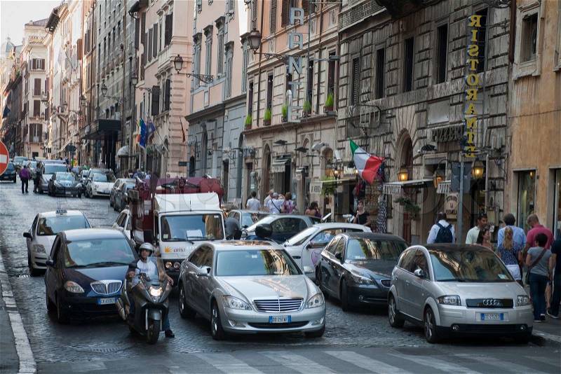 RED LIGHT TRAFFIC, ROME, ITALY - SEPTEMBER 25, 2011:Parked cars and Sunday afternoon traffic in urban Rome, stock photo