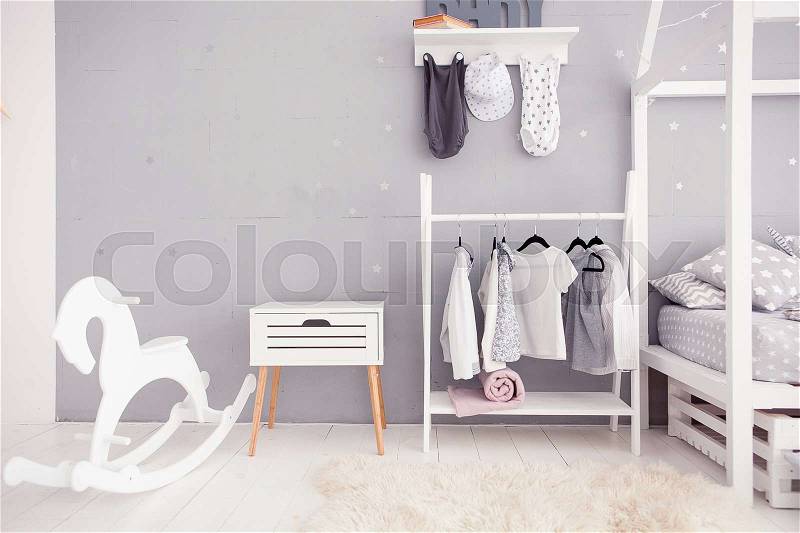 Empty nursery room with clear wall, nightstand, toys and wooden horse, stock photo