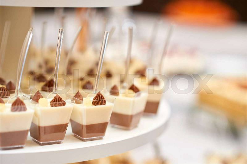 Close up of small servings of vanilla and cocoa mousse at the restaurant copyspace, stock photo