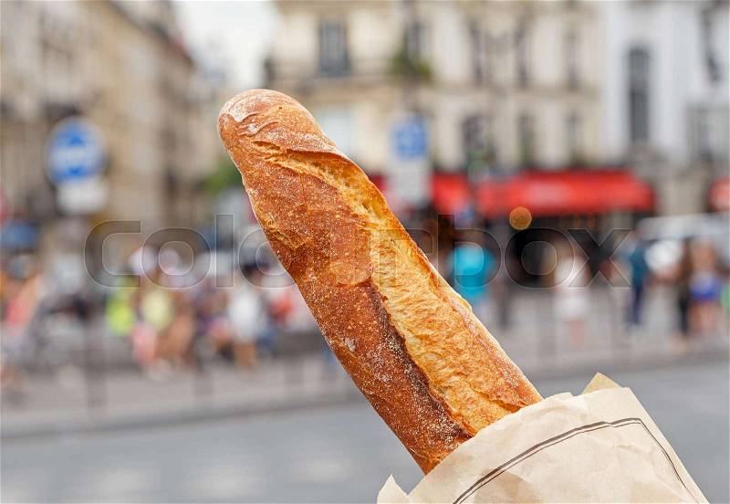 French baguette against street in Paris, stock photo