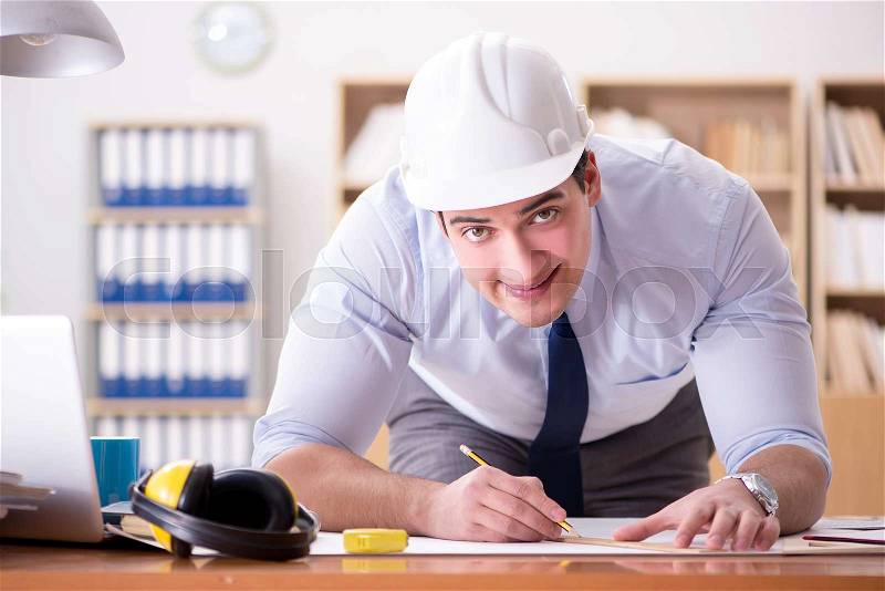 Engineer supervisor working on drawings in the office, stock photo