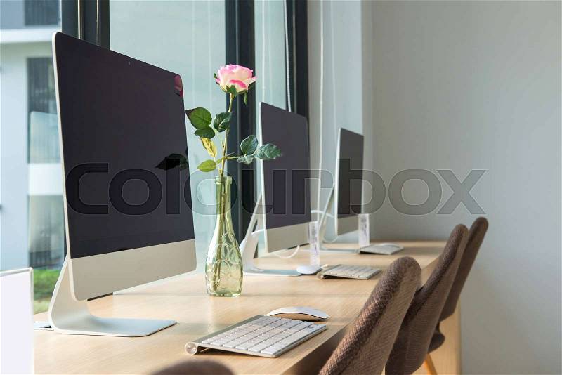 Computer desktop with keyboard, diary and other accessories on table in cafe, stock photo