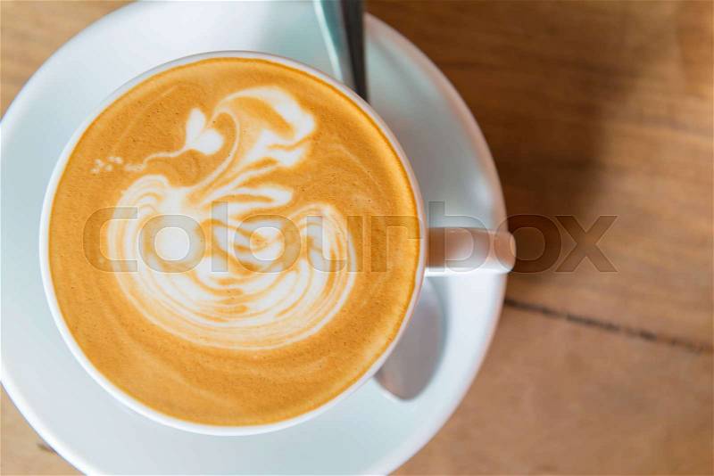 Latte art coffee or cappuccino on wooden table background, stock photo