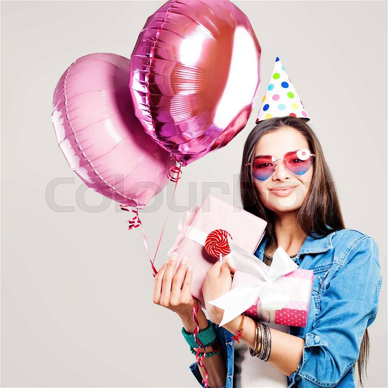 Happy Fashion Model Woman with Holiday Balloons and Birthday Gift , stock photo