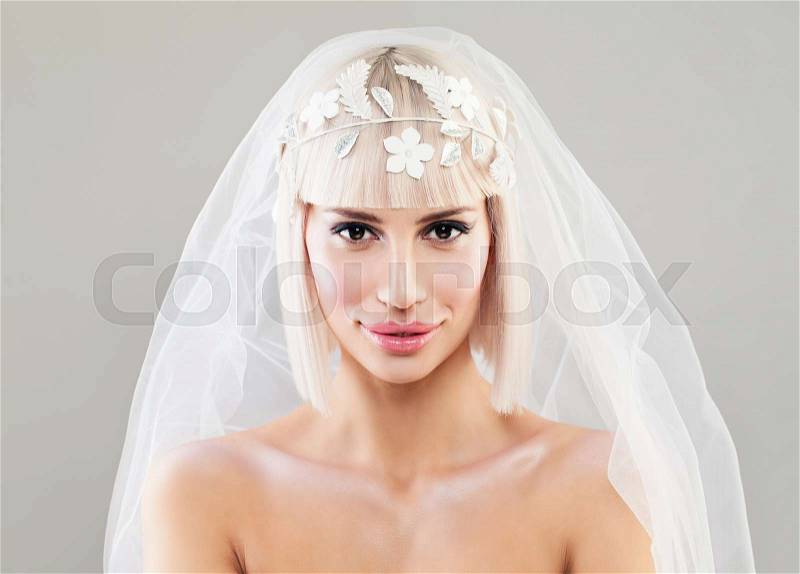 Beautiful Young Bride Woman. Blonde Fashion Model with Bob Hairstyle, Makeup and Veil, stock photo