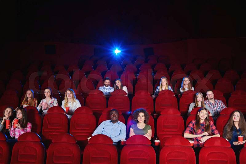 Cinema auditorium with spectators sitting watching a movie copyspace enjoyment recreation entertainment holidays weekend premiere films comedies activity concept, stock photo