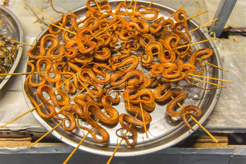 Grilled snakes on sale for food market in China, stock photo