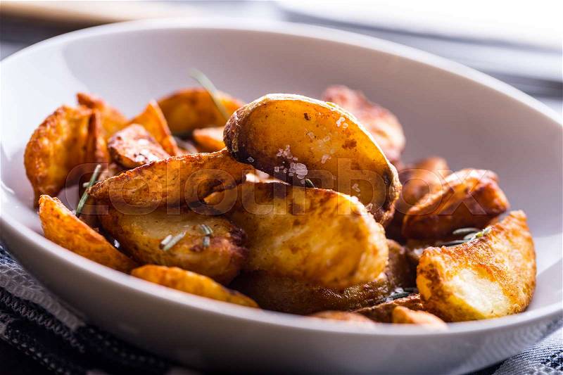 Potato. Roasted potatoes. American potatoes with salt rosemary and cumin. Roasted potato wedges delicious crispy, stock photo