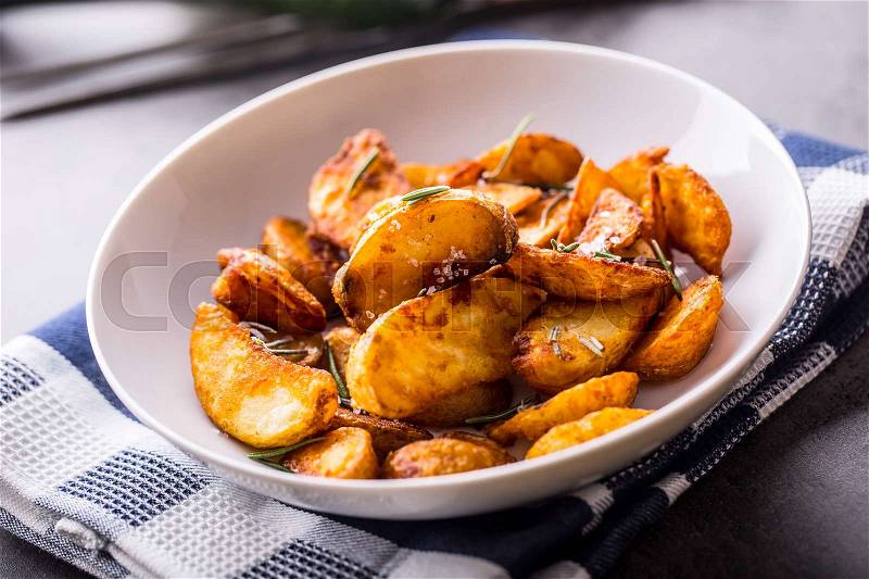 Potato. Roasted potatoes. American potatoes with salt rosemary and cumin. Roasted potato wedges delicious crispy, stock photo