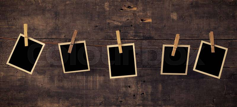 Five old photo frames on a rustic wooden wall, stock photo
