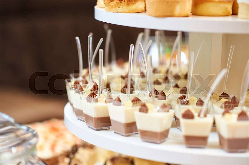 Cropped shot of delicious portioned vanilla and cocoa mousse served at the restaurant, stock photo