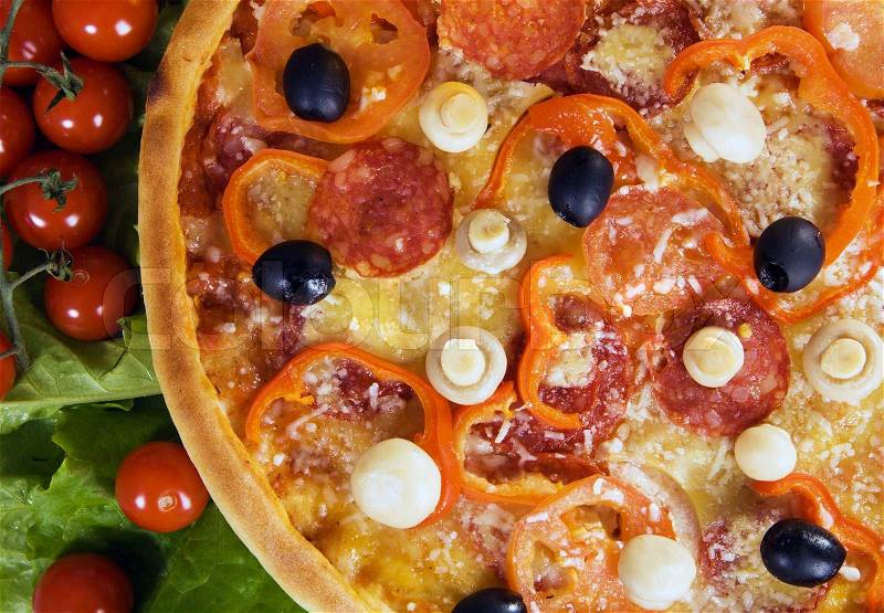 Closeup picture of a pizza with vegetables and cherry tomato, stock photo