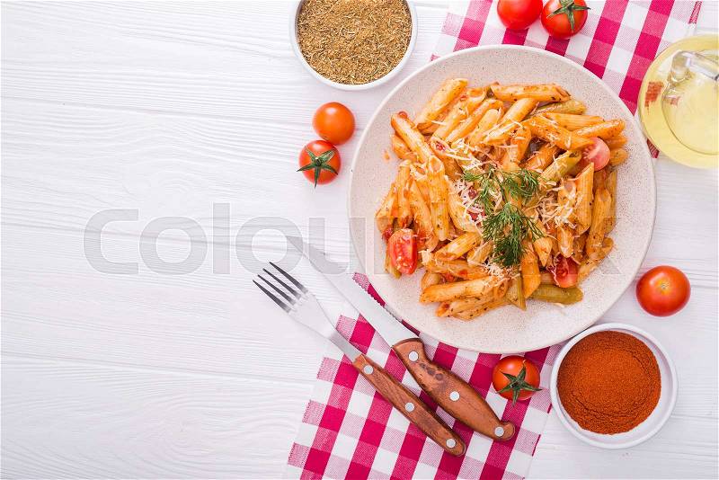 Delicious penne pasta on wood white table. tasty italian dinner, stock photo
