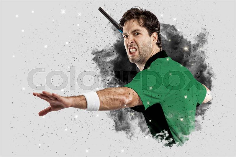 Tennis Player with a green uniform coming out of a blast of smoke , stock photo