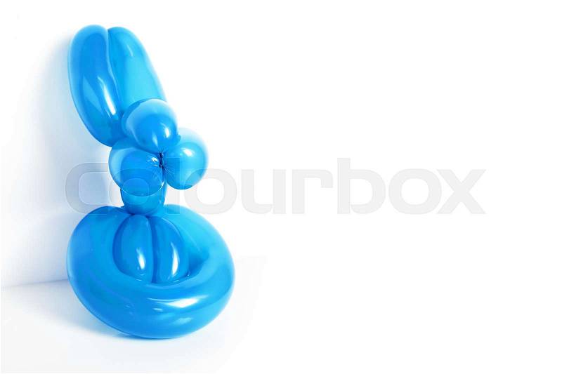 Simple blue twisted balloon animal rabbit on white. Toy of balloons, bunny, free space for text. Balloon art, stock photo
