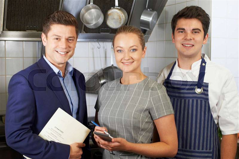 Portrait Of Restaurant Team Standing In Kitchen, stock photo