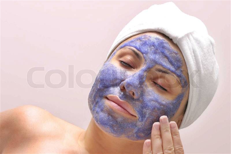 Serene female with beauty scrub salt mask on her face, stock photo