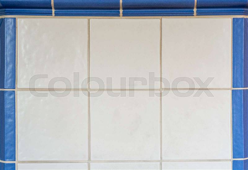 White tiles from a tiled stove framed with blue tiles from the front, stock photo