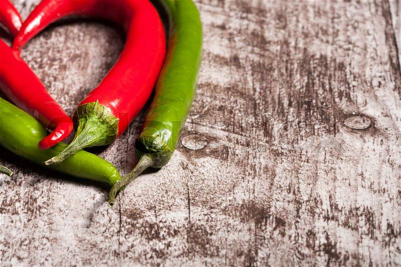 Spicy pepper on wooden background. Over top view. Chilli and hot, stock photo
