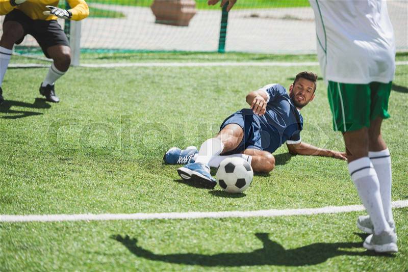 Group of soccer players during soccer match on pitch, stock photo