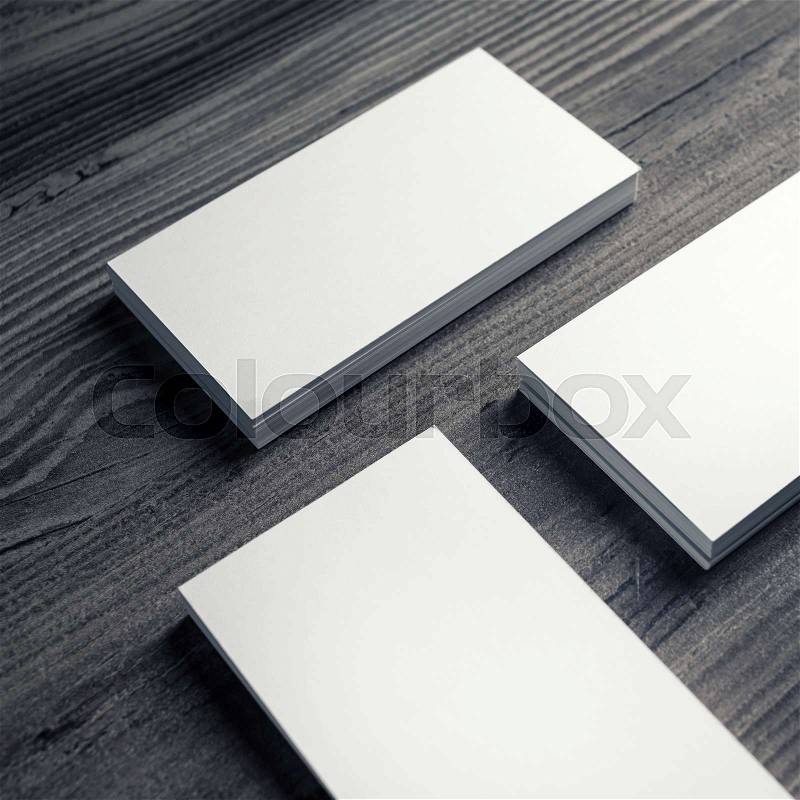 Photo of blank business cards on a wooden background. Template for ID. Business cards mockup, stock photo