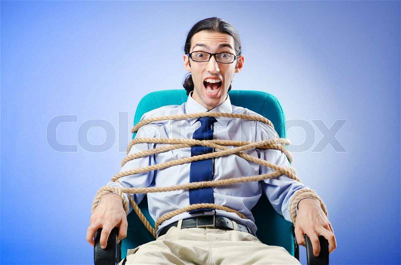 Young businessman tied with rope, stock photo