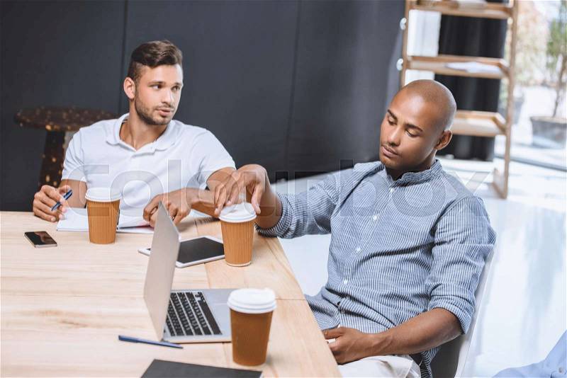 Multicultural business people discussing business strategy at meeting in office, stock photo