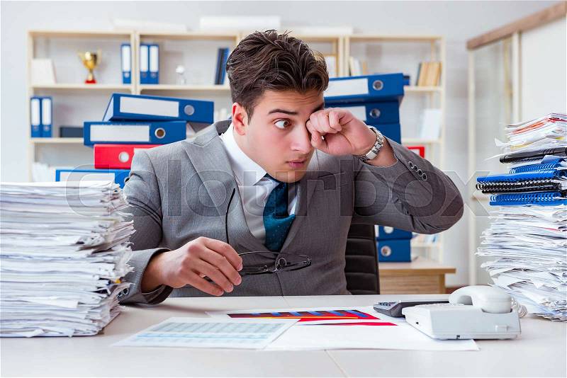 Businessman busy with much paperwork, stock photo