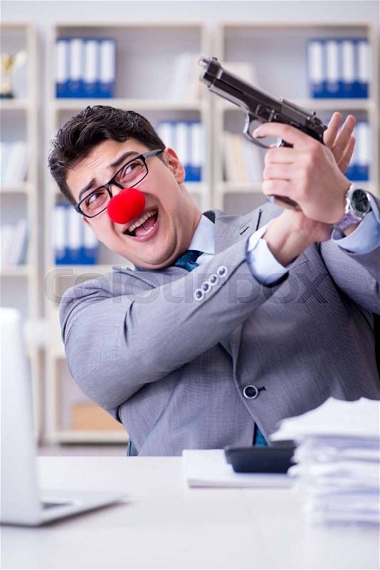 Clown businessman working in the office frustrated commiting suicide, stock photo