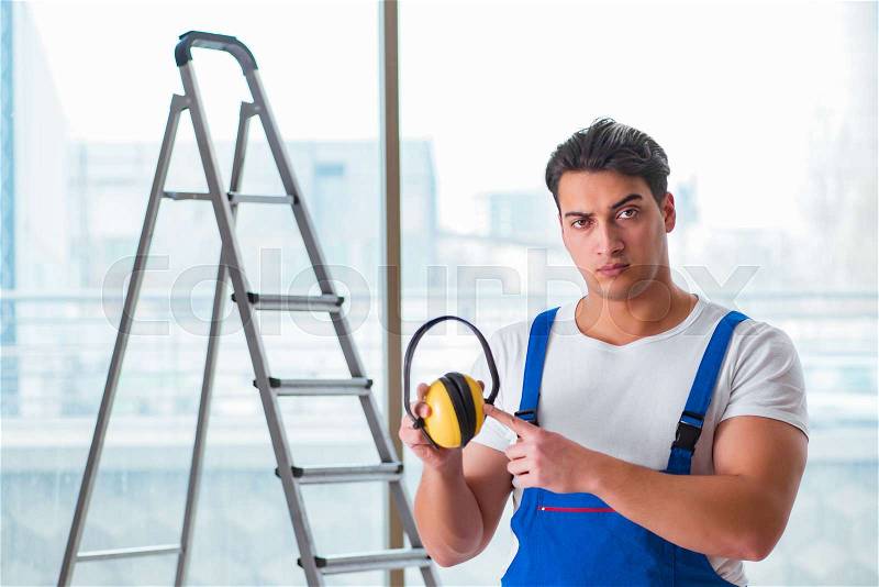 Worker with noise cancelling headphones, stock photo