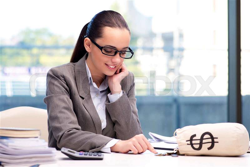 Businesswoman with money sack bag in office, stock photo