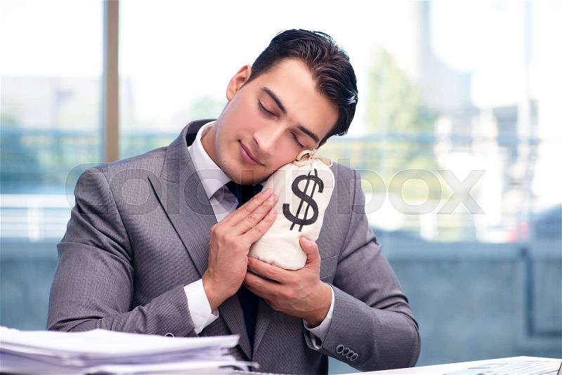 Businessman with money sack bag in office, stock photo