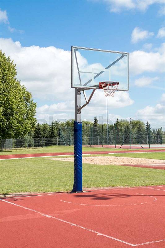 Public outdoor basketball court in a park, stock photo