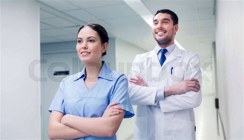 Healthcare, profession, people and medicine concept - smiling doctor in white coat and nurse at hospital, stock photo