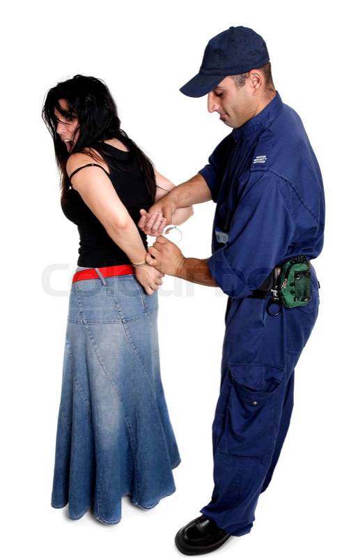 A security officer apprehends and handcuffs a female person, stock photo