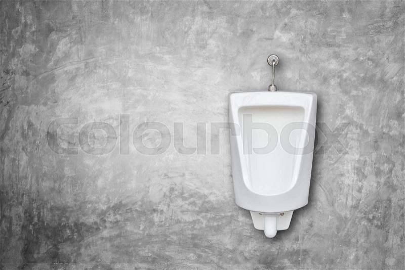 One of new white ceramic outdoor urinals in men public toilet install on the grey wall. Composition with free empty space for text or design, stock photo