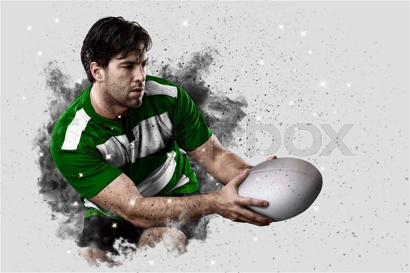 Rugby Player with a green uniform coming out of a blast of smoke , stock photo