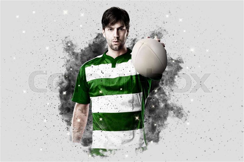 Rugby Player with a green uniform coming out of a blast of smoke , stock photo