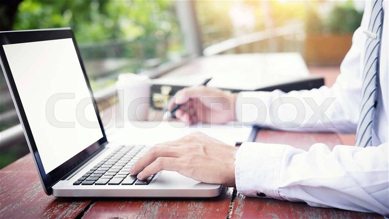 Businessman using modern laptop for working at personal space outdoor, wireless connection internet on his notebook computer, stock photo