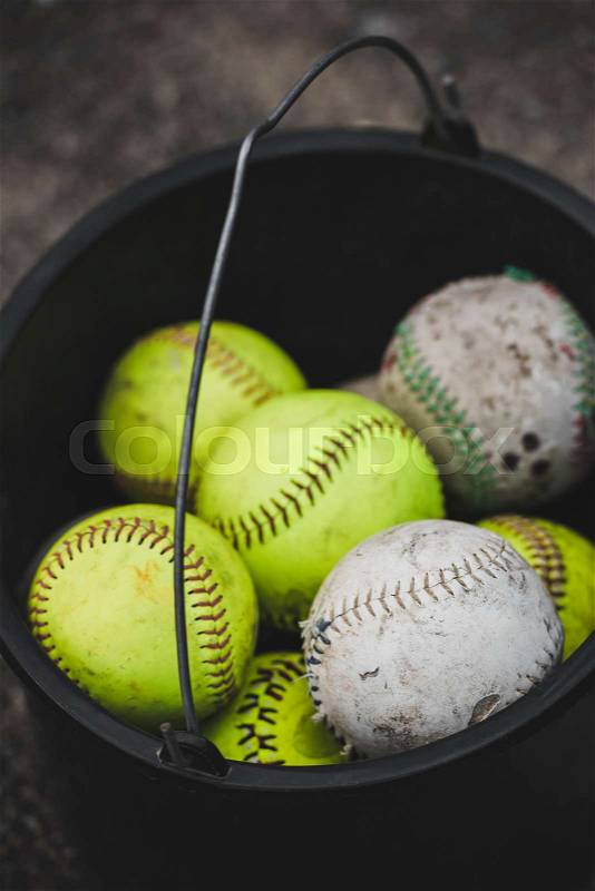Close-up above view of bucket full of baseball balls, stock photo