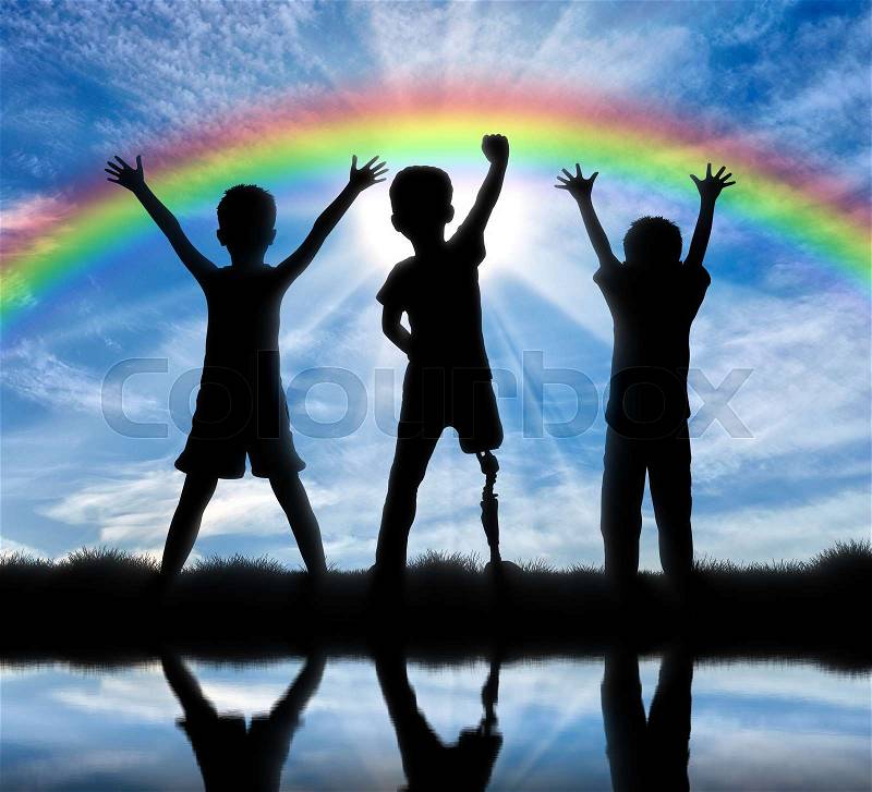 Children with disabilities and friendship with them concept. Happy disabled boy with a prosthetic leg standing among their friends, near the river and the rainbow, stock photo