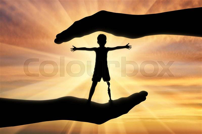 Help children with disabilities concept. Happy disabled boy with a prosthetic leg standing in the hands of human help, stock photo