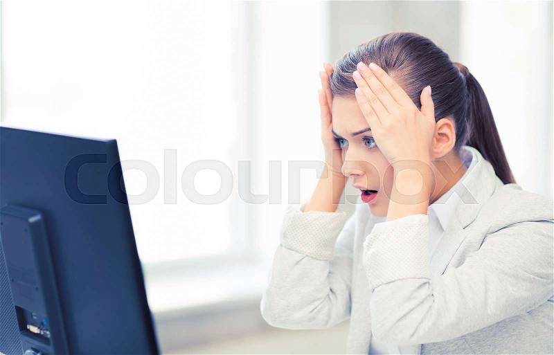 Picture of stressed student with computer in office, stock photo
