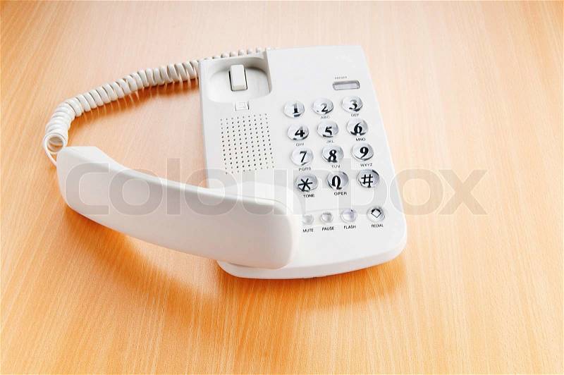 White office phone on the flat surface, stock photo