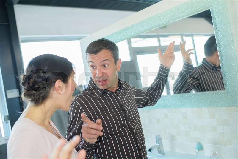 Young couple having a dispute in the bathroom, stock photo