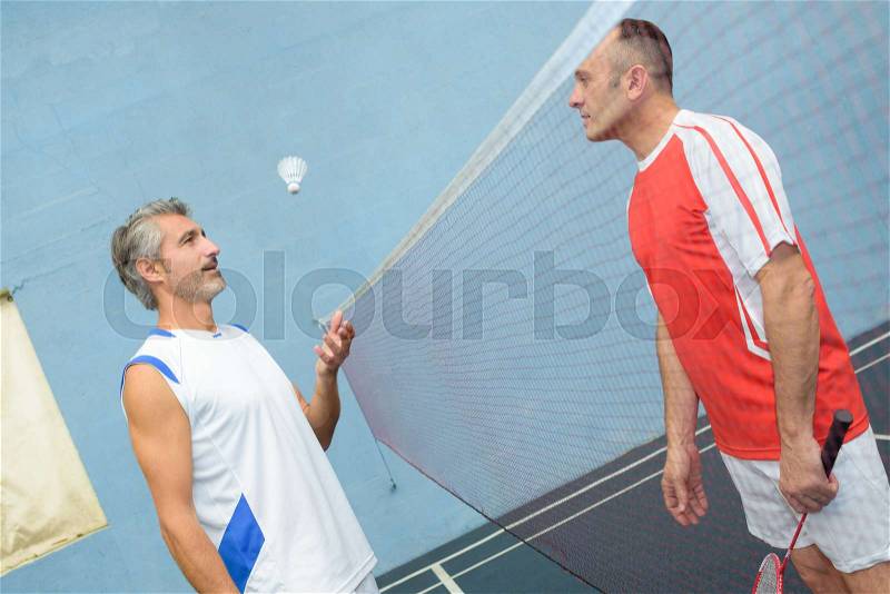 Man gets ready to start a new badminton match, stock photo